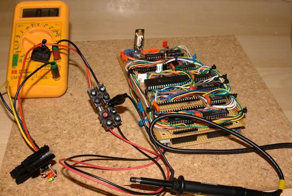 A board hooked up to the multimeter to measure current.