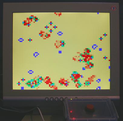 A photo of the screen with the improved game of Life running with colour indicating age.