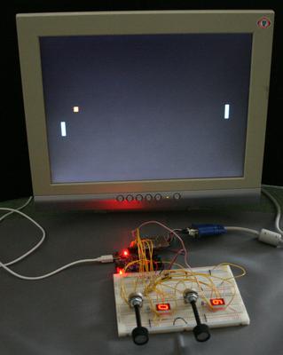 Photo of Pong on a VGA monitor with a breadboard displaying scores and controls