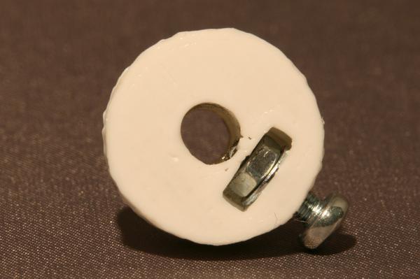 A printed timing belt pulley with an oval spindle hole due to wear.